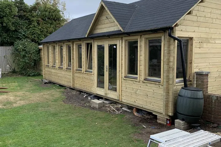 Timber garden office building with a slate roof