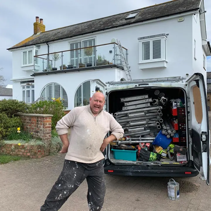 Conor McIlvenny standing by the Emerald Builders van