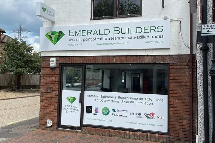 Emerald Builders shopfront with signage listing kitchens, bathrooms, refurbishments and extensions